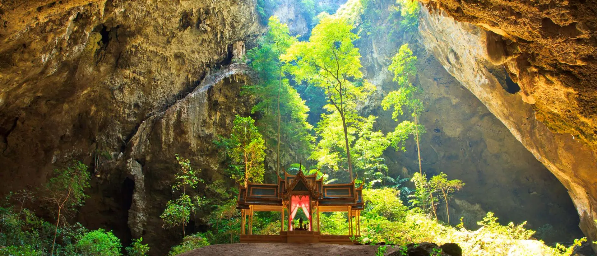 Sunlight shines down through Phraya Nakorn cave hole on pavillion of the king, Sam Roi Yot National Park