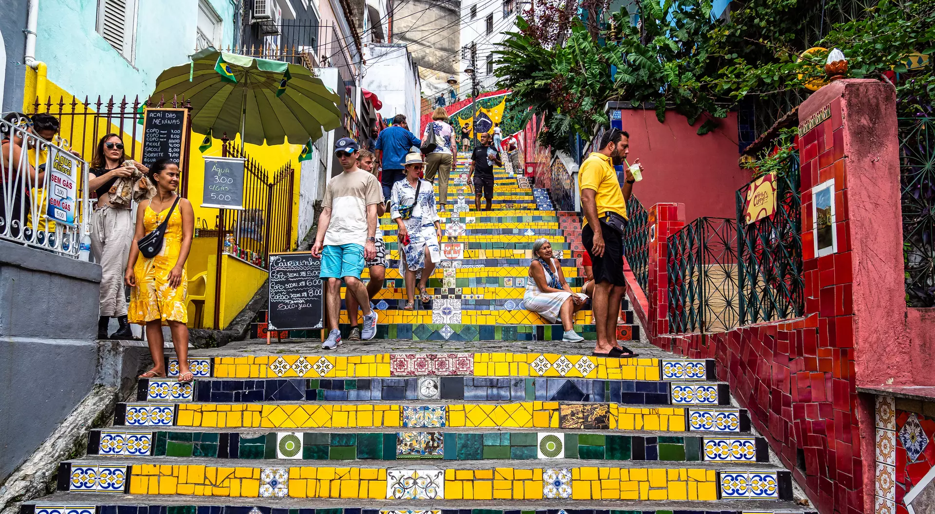Colorful tiled steps in a lively street, with people walking and enjoying the vibrant atmosphere.