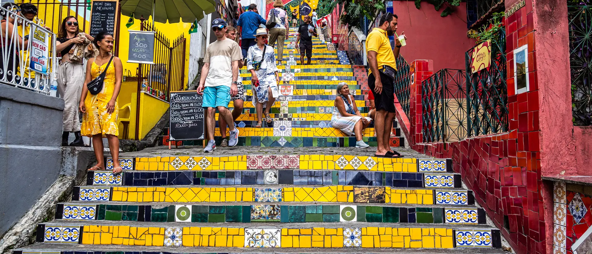 Colorful tiled steps in a lively street, with people walking and enjoying the vibrant atmosphere.