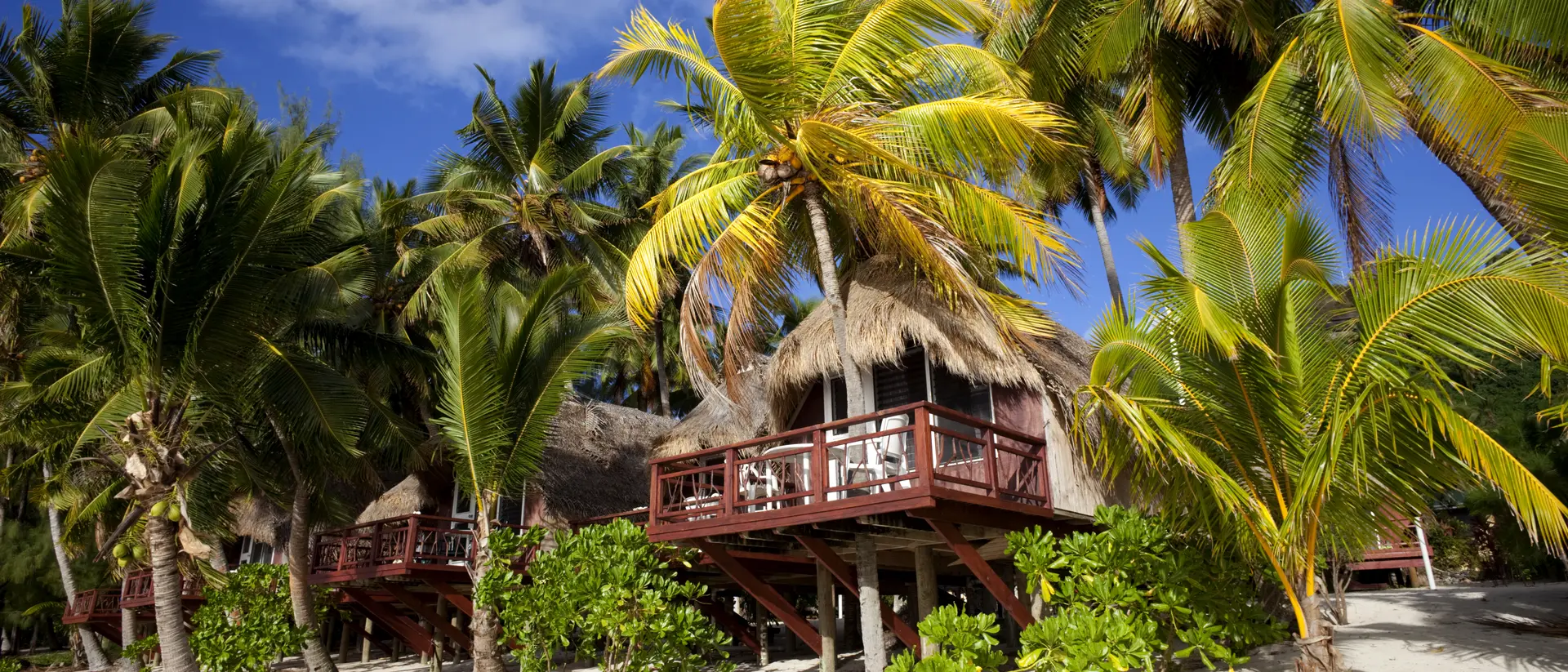 Aitutaki, Cook Islands A line of beach huts in Aitutaki, a tropical destination in the Cook Island