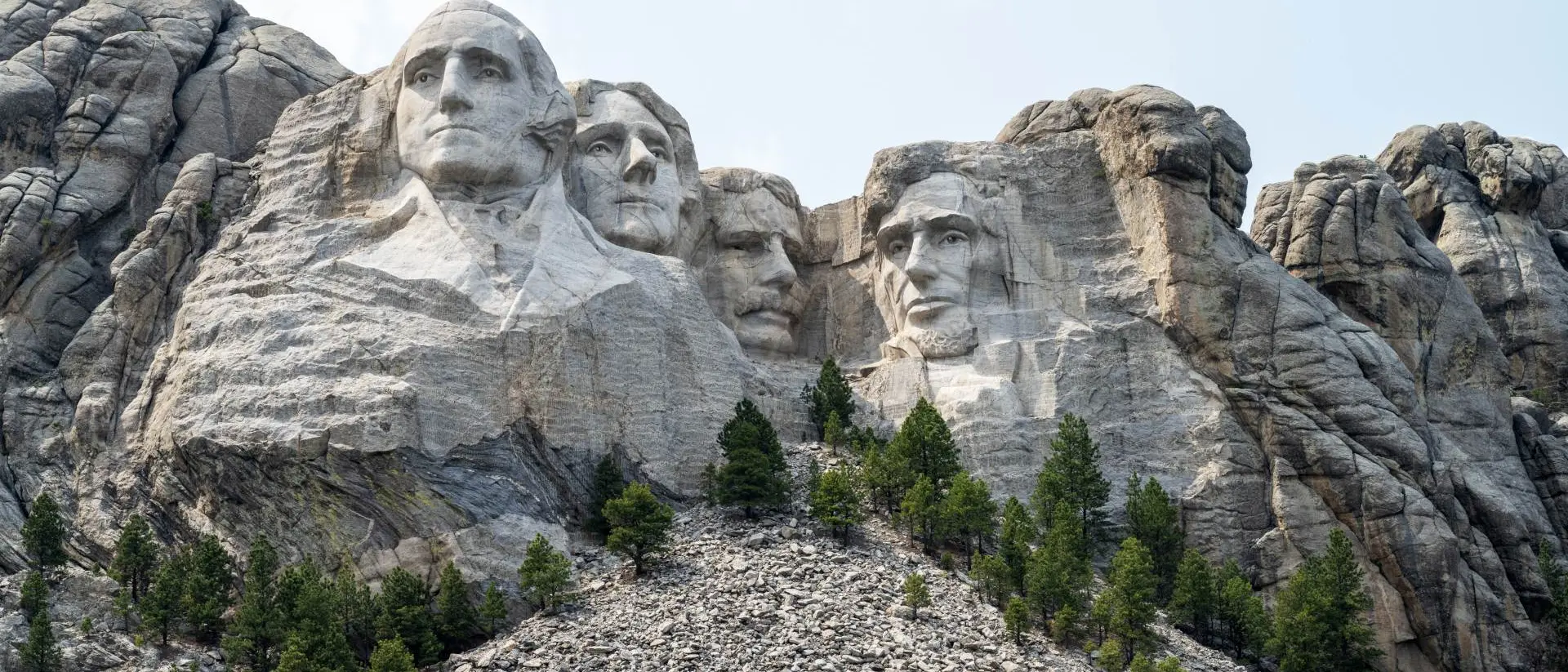 Close up view of Mount Rushmore under a blue sky