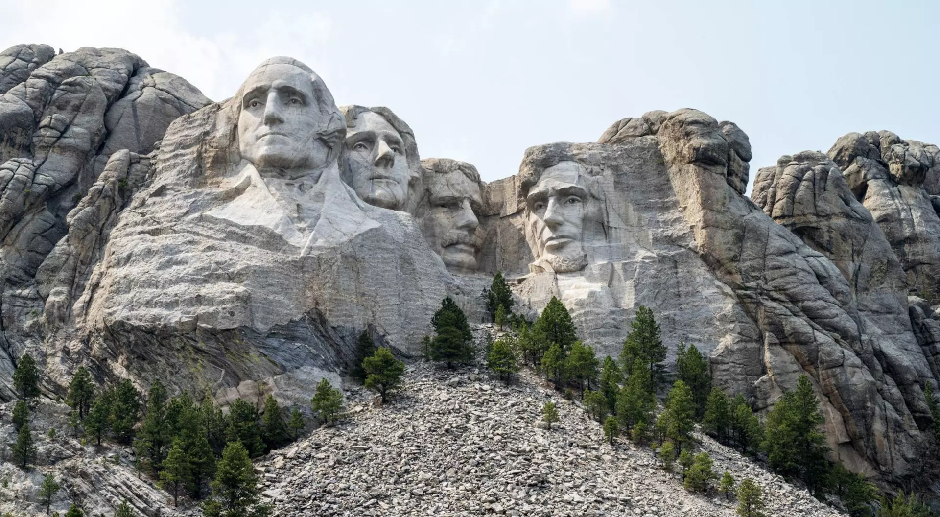 Close up view of Mount Rushmore under a blue sky