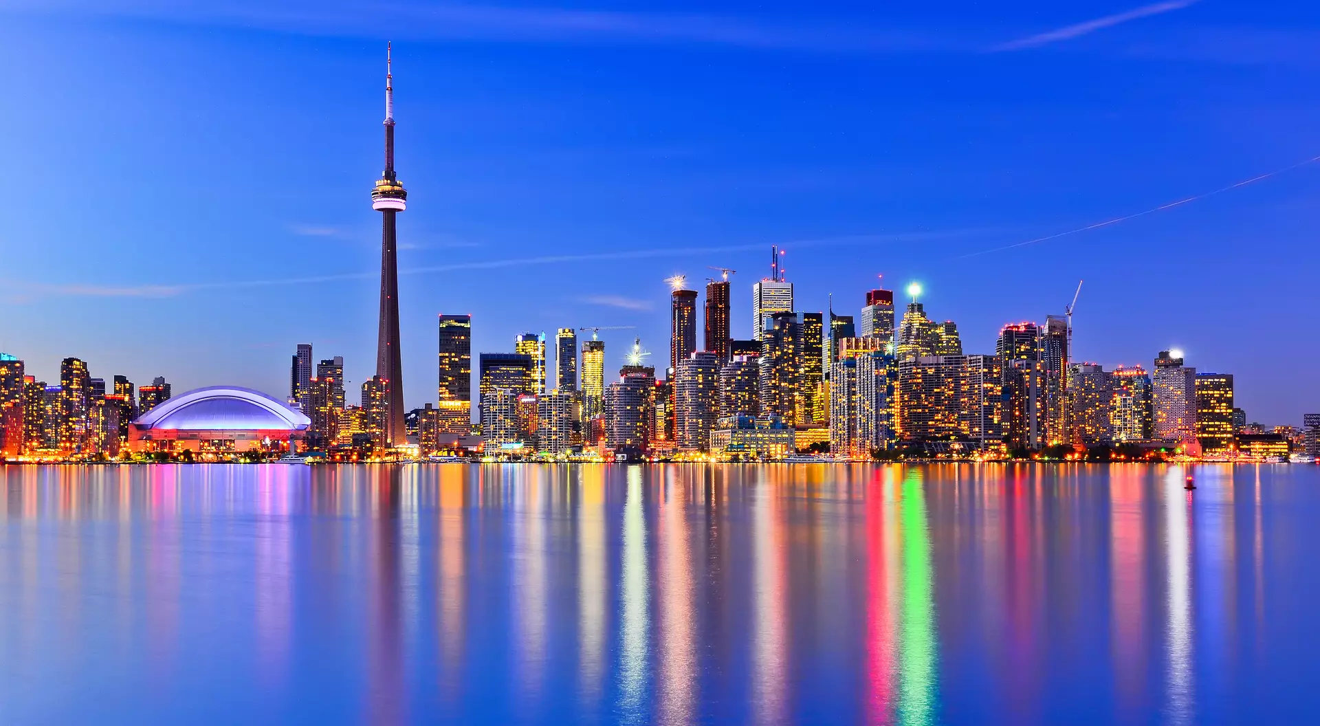 The city skyline at twilight reflecting in lake ontario
