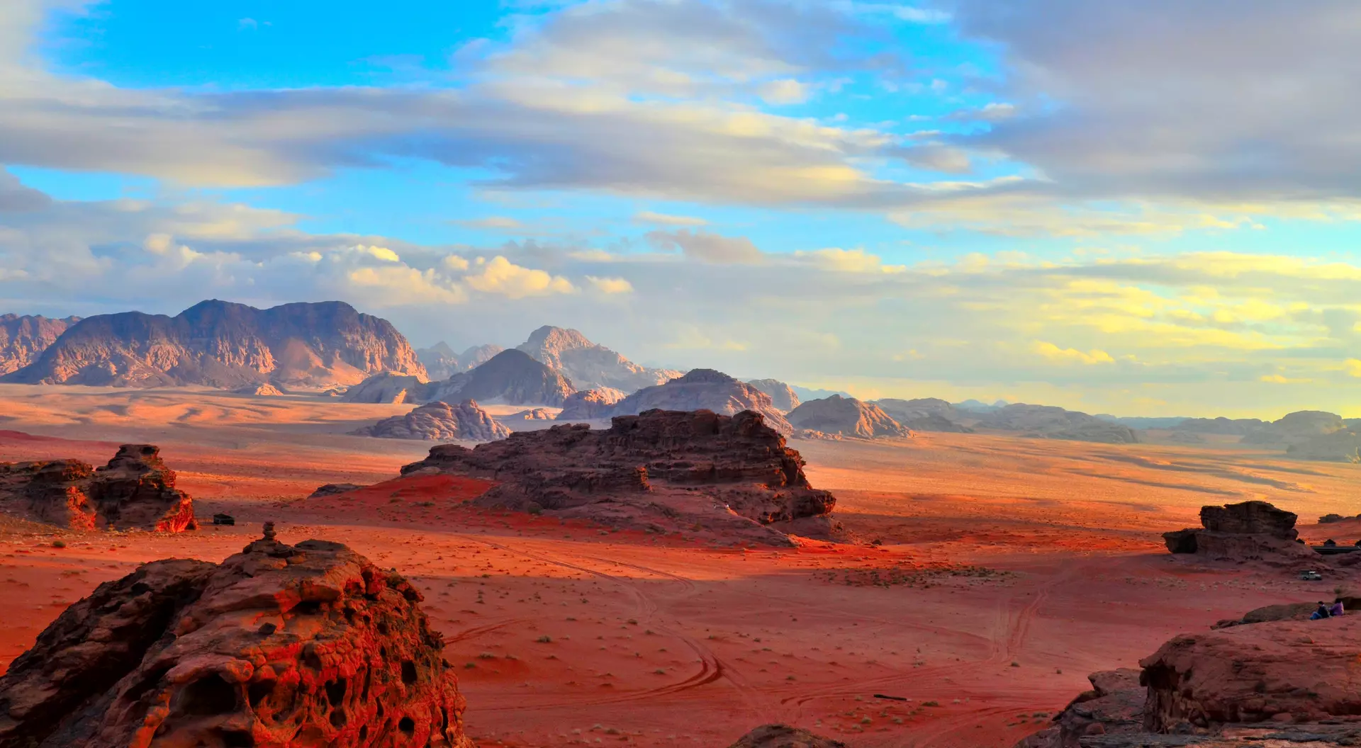 Sunset over rock formations and red desert