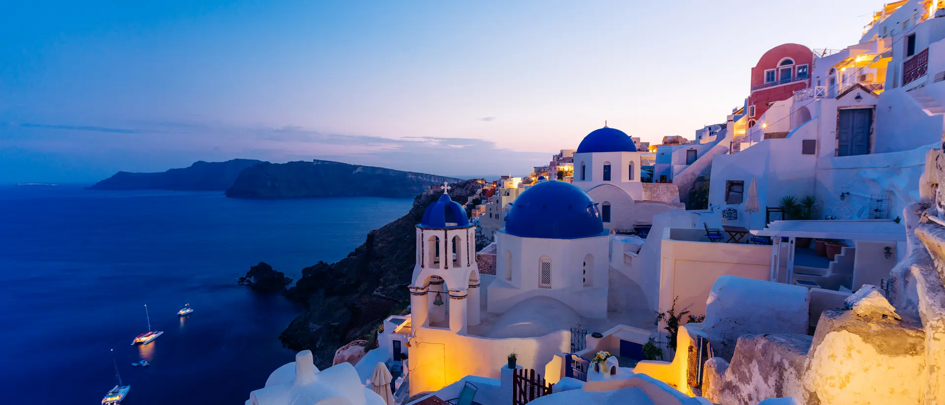 Famous Oia blue dome churches at twilight