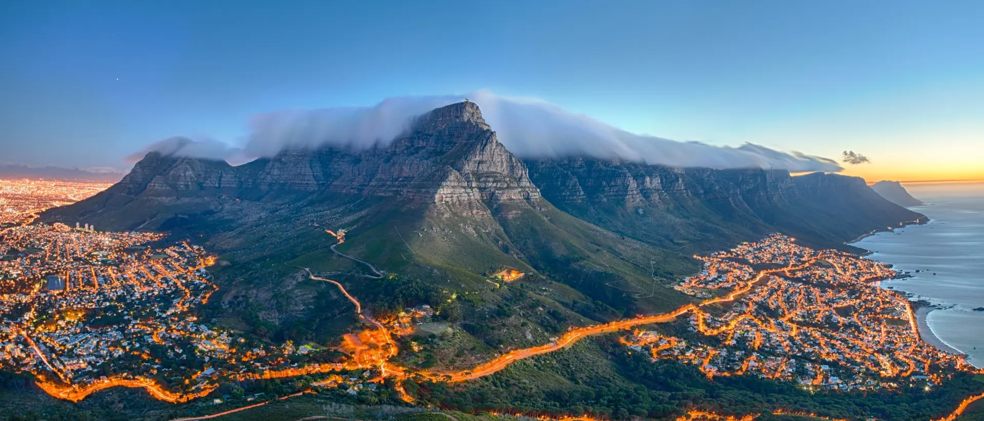 South Africa Table Mountain covered by its typical cloud table cloth and the twelve Apostles