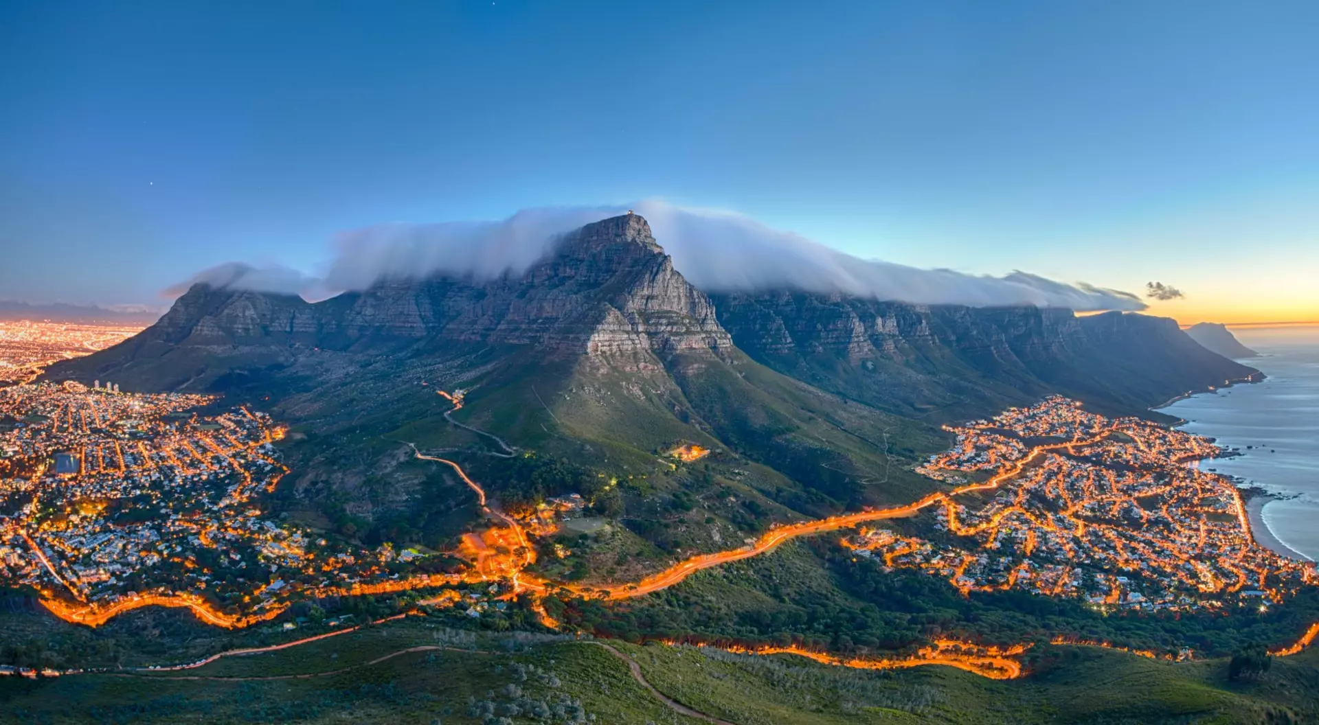 South Africa Table Mountain covered by its typical cloud table cloth and the twelve Apostles