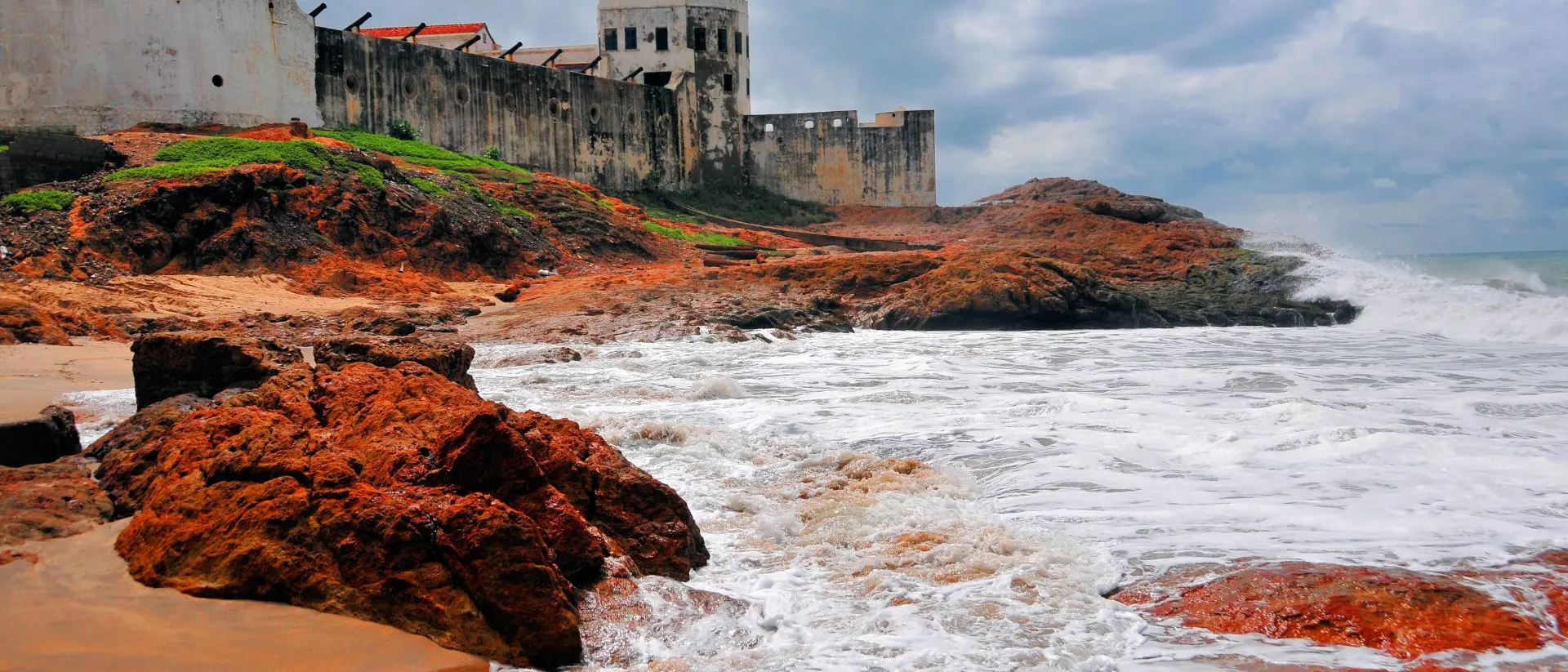 Cape Coast castle, the ocean and red rocks