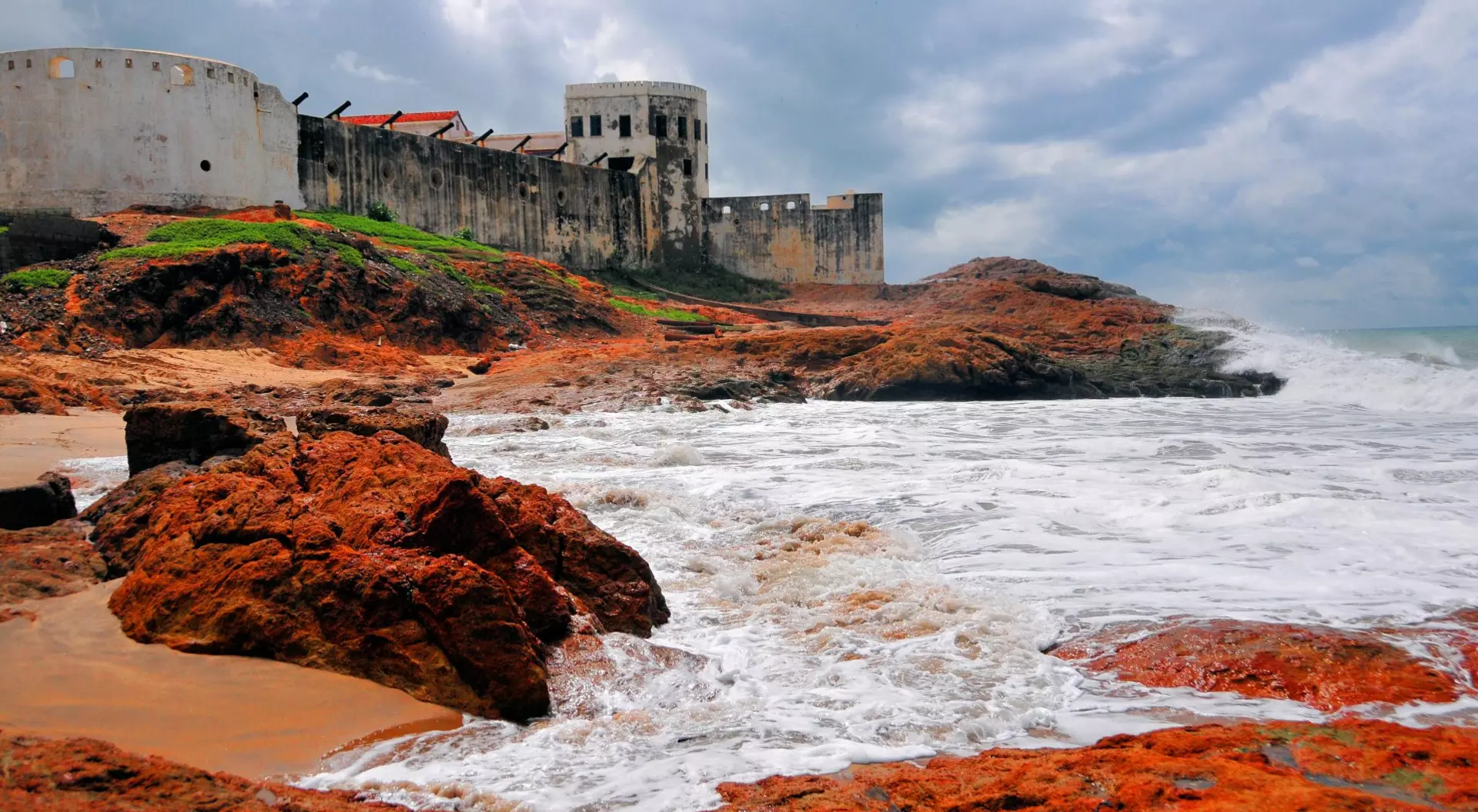 Ghana Cape Coast castle, the ocean and red rocks