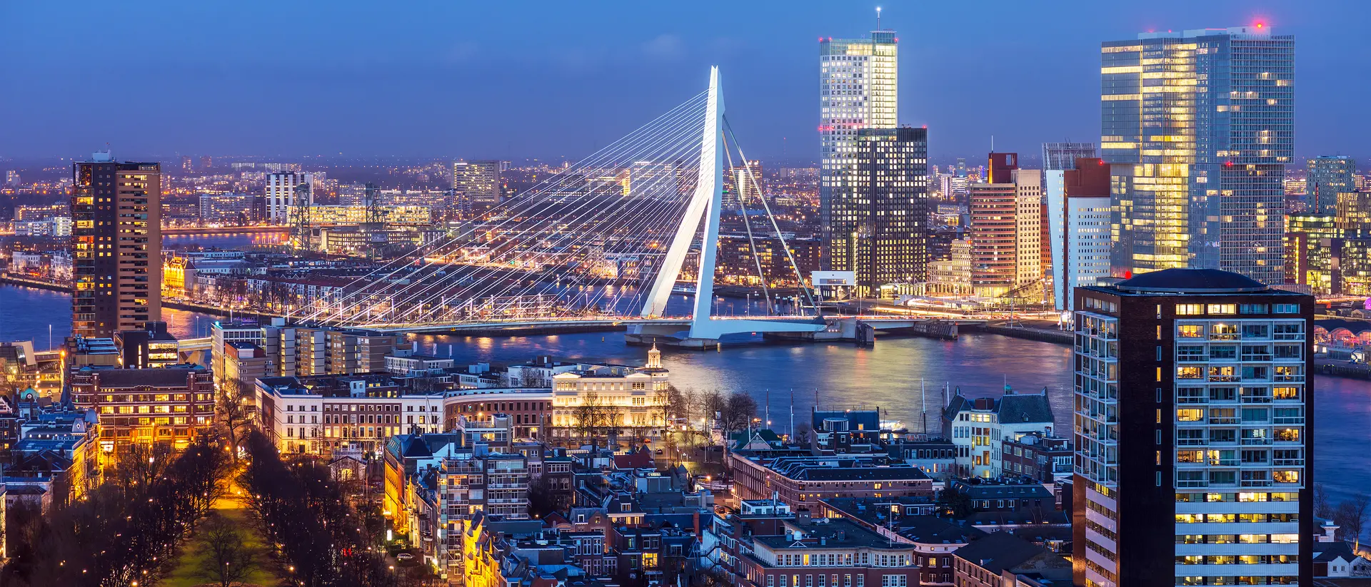 Aerial shot of Rotterdam skyline with Erasmus bridge at twilight as seen from the Euromast tower