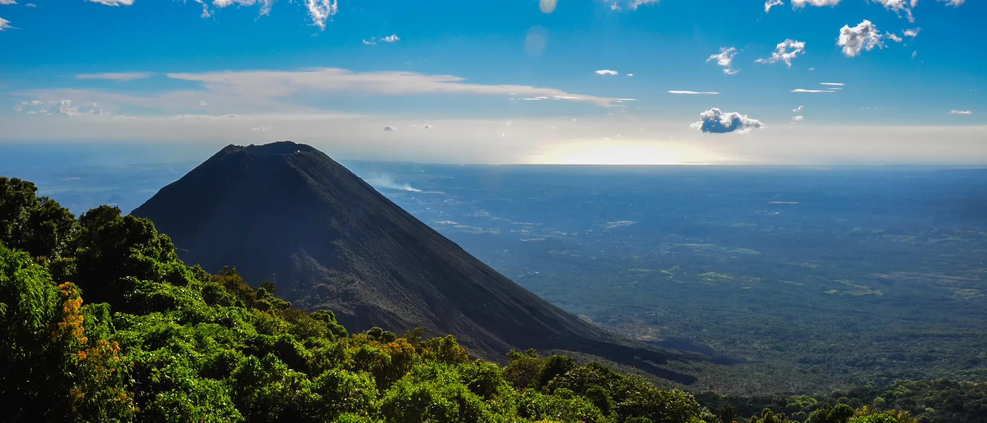 View of volcano with lush hungles and horizon