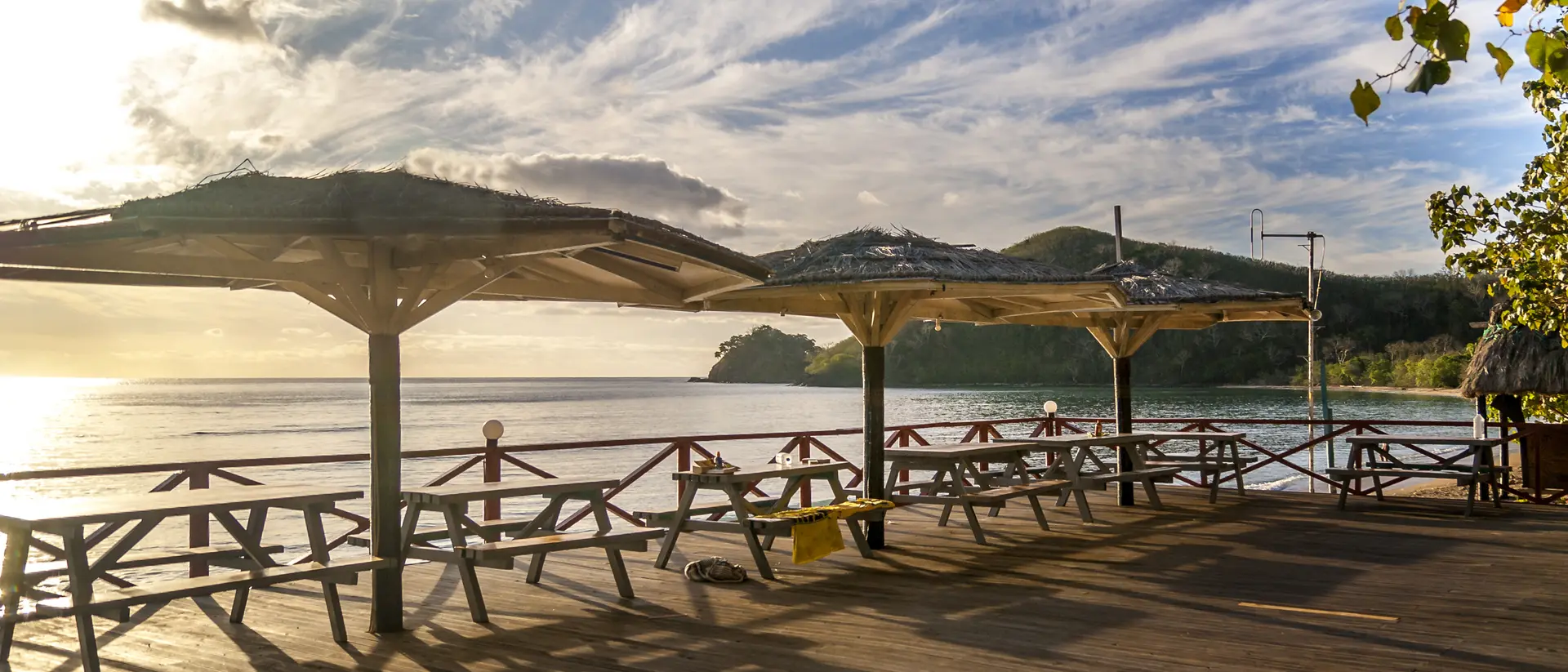 A group of picnic tables over look the beautiful pacific ocean sunset in Fiji 