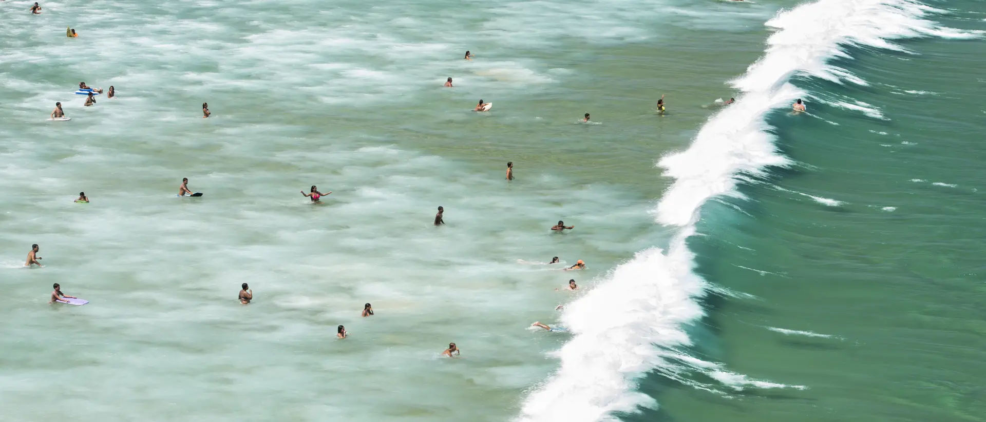 Geribá Beach Aerial view of people swimming and surfing as the swell reaches the coastline Geribá Beach in Búzios