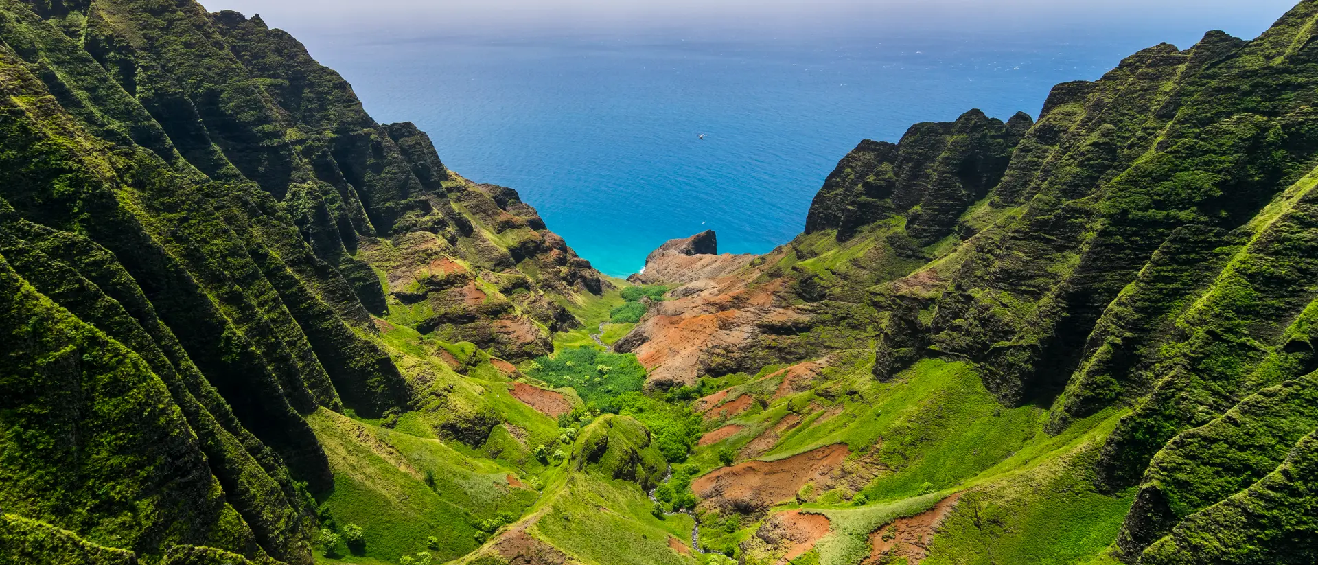 Aerial landscape view of cliffs and green valley over the pacific ocean