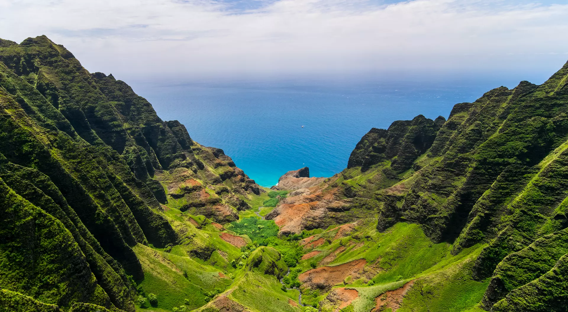 Aerial landscape view of cliffs and green valley over the pacific ocean