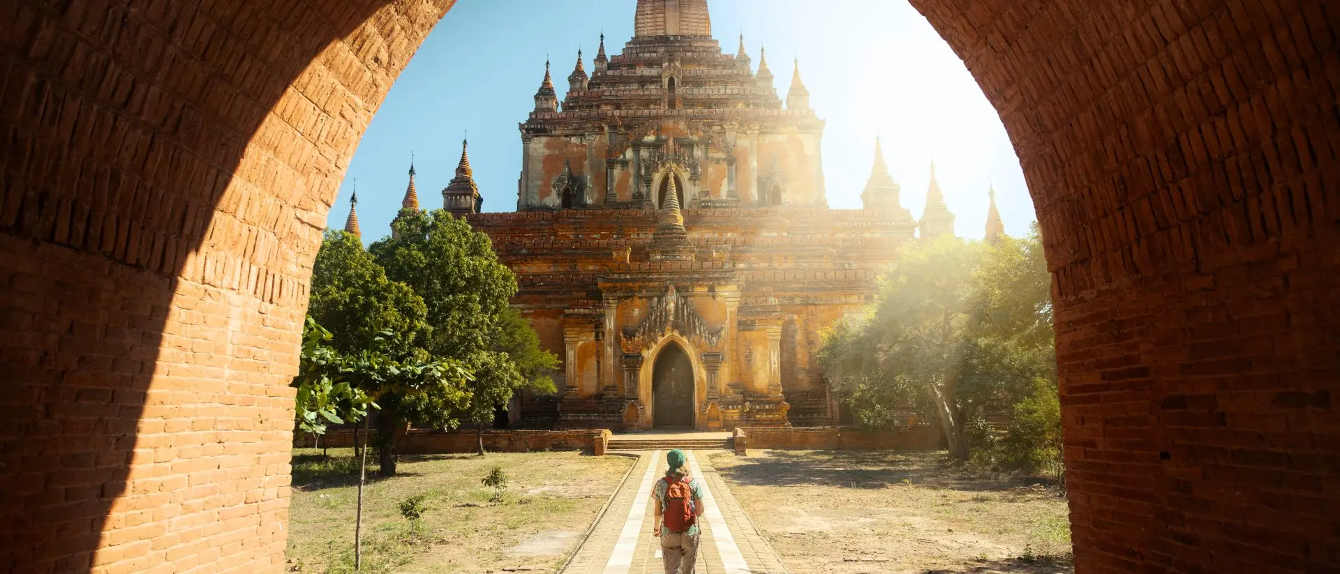 Traveler walking along the road to the Htilominlo temple in Bagan, Myanmar