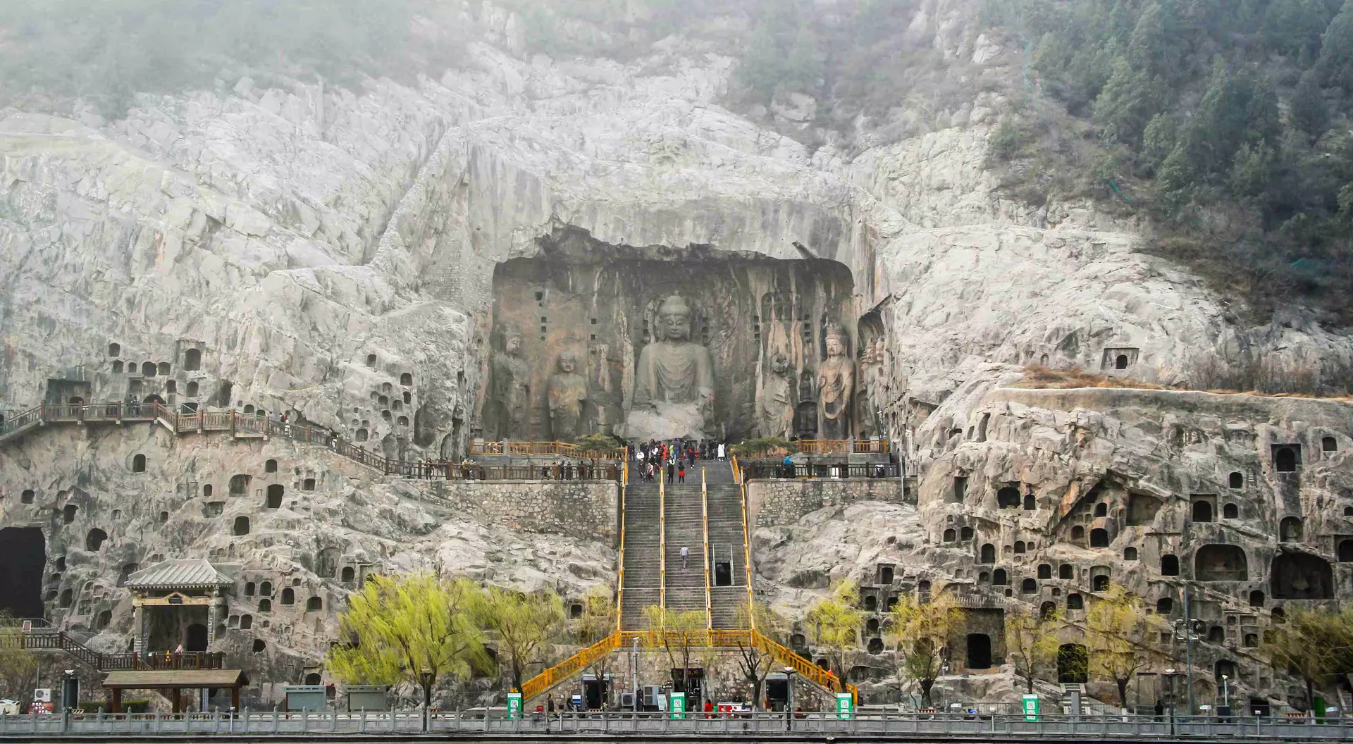 Longmen Grottoes The Longmen Grottoes comprise of more than 2,300 caves and niches carved into the steep limestone cliffs