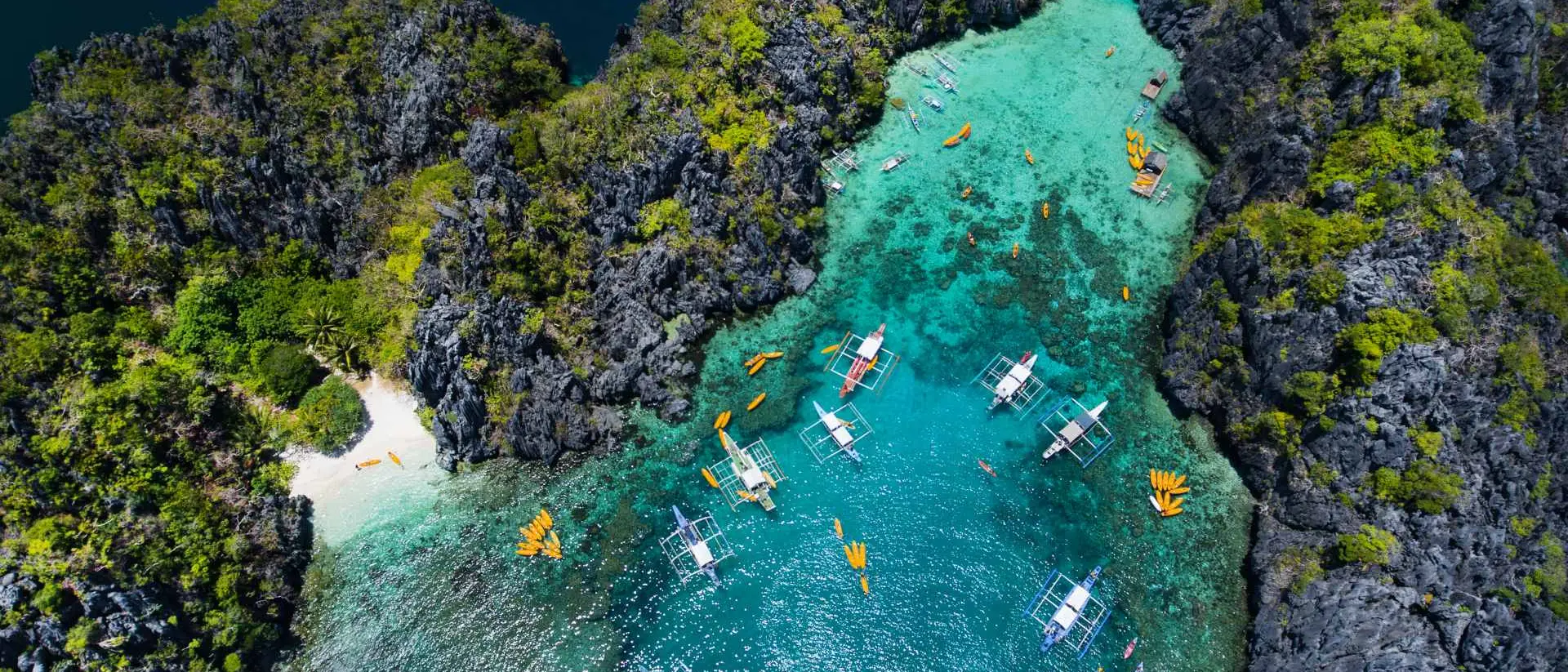 Aerial view of crystal blue lagoon with boats in El Nido Palawan Philippines