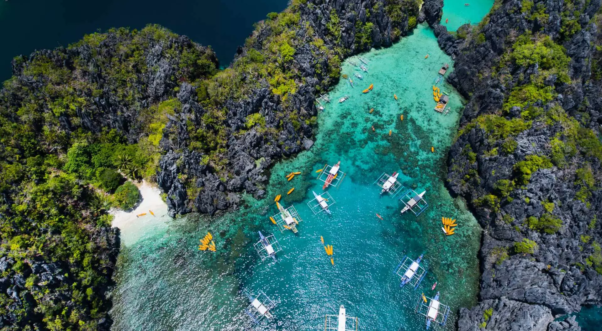 El Nido Palawan Aerial view of crystal blue lagoon with boats in El Nido Palawan Philippines