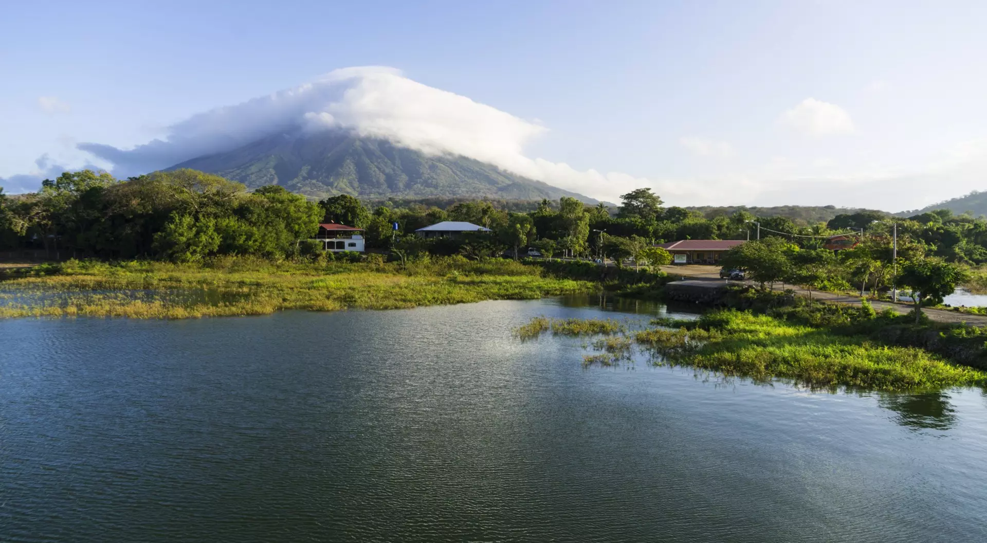 Morning view from Lake Nicaragua to island Ometepe and volcano Concepcion with white clouds on it
