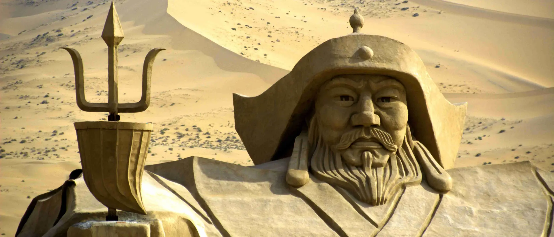 Genghis Khan statue in the middle of Badain Jaran desert. This desert is home to some of the tallest stationary dunes on Earth