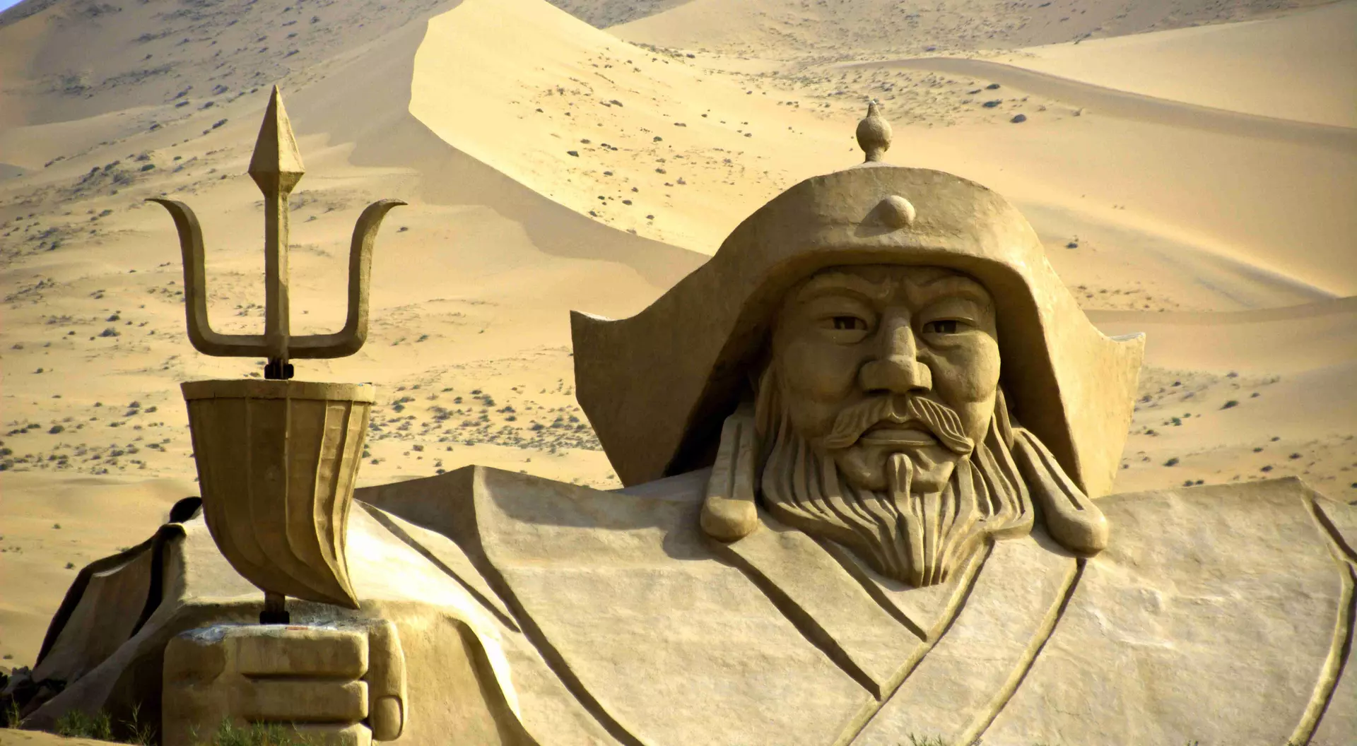 Badain Jaran desert Genghis Khan statue in the middle of Badain Jaran desert. This desert is home to some of the tallest stationary dunes on Earth