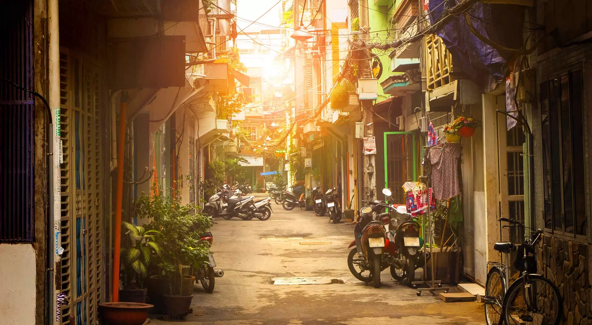 Ho Chi Minh City Motor bikes lined down narrow street of Ho Chi Minh city, Vietnam