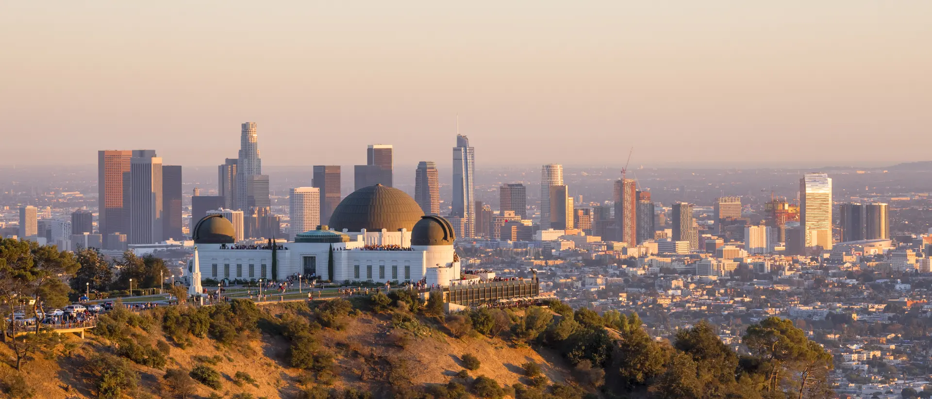 Downtown skyline behind Griffith Observatory at sunset