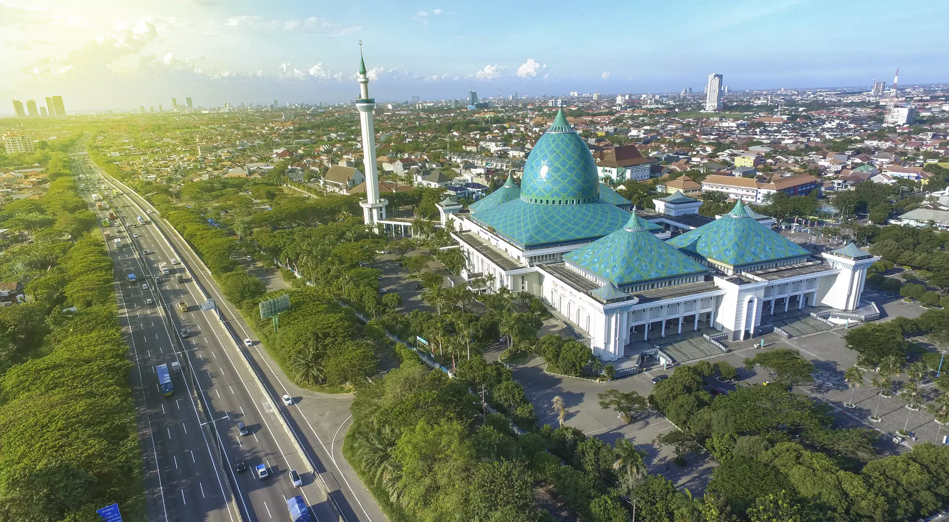 Skyline of Surabaya with Al Akbar Mosque in the foreground. Surabaya is a port city of on the Indonesian island of Java.