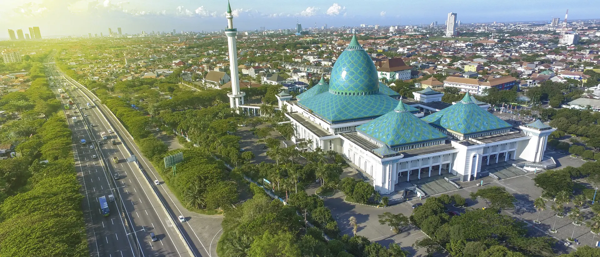 Surabaya, Java Skyline of Surabaya with Al Akbar Mosque in the foreground. Surabaya is a port city of on the Indonesian island of Java.