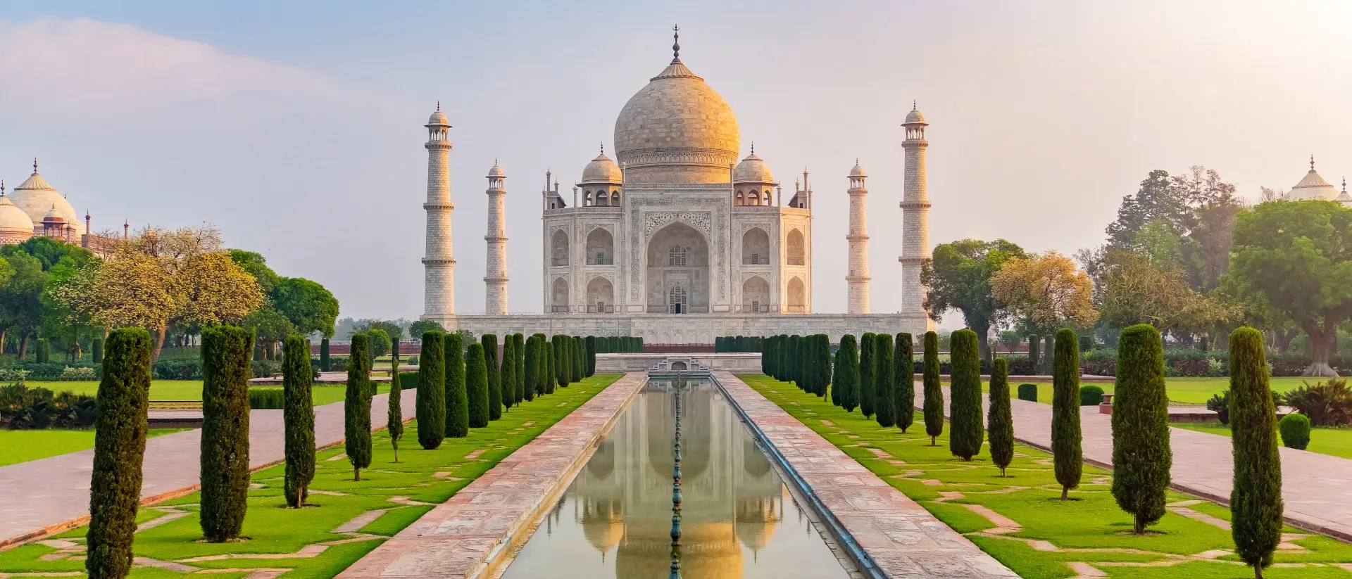 Taj Mahal front view reflected on the reflection pool, an ivory-white marble mausoleum Agra, Uttar Pradesh, India. One of the seven wonders of the world