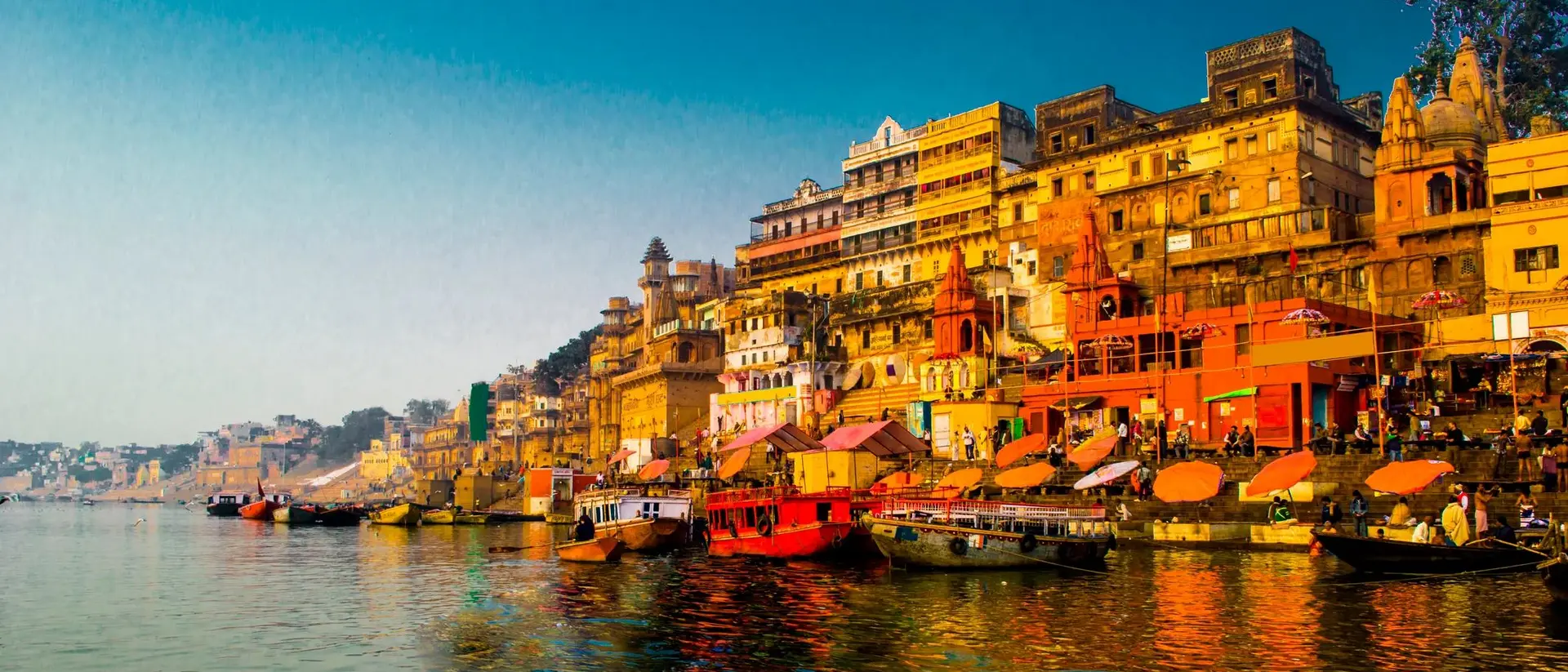 View of the Ganges River during the morning with intense colour shitting the shoreline of Varanasi, India