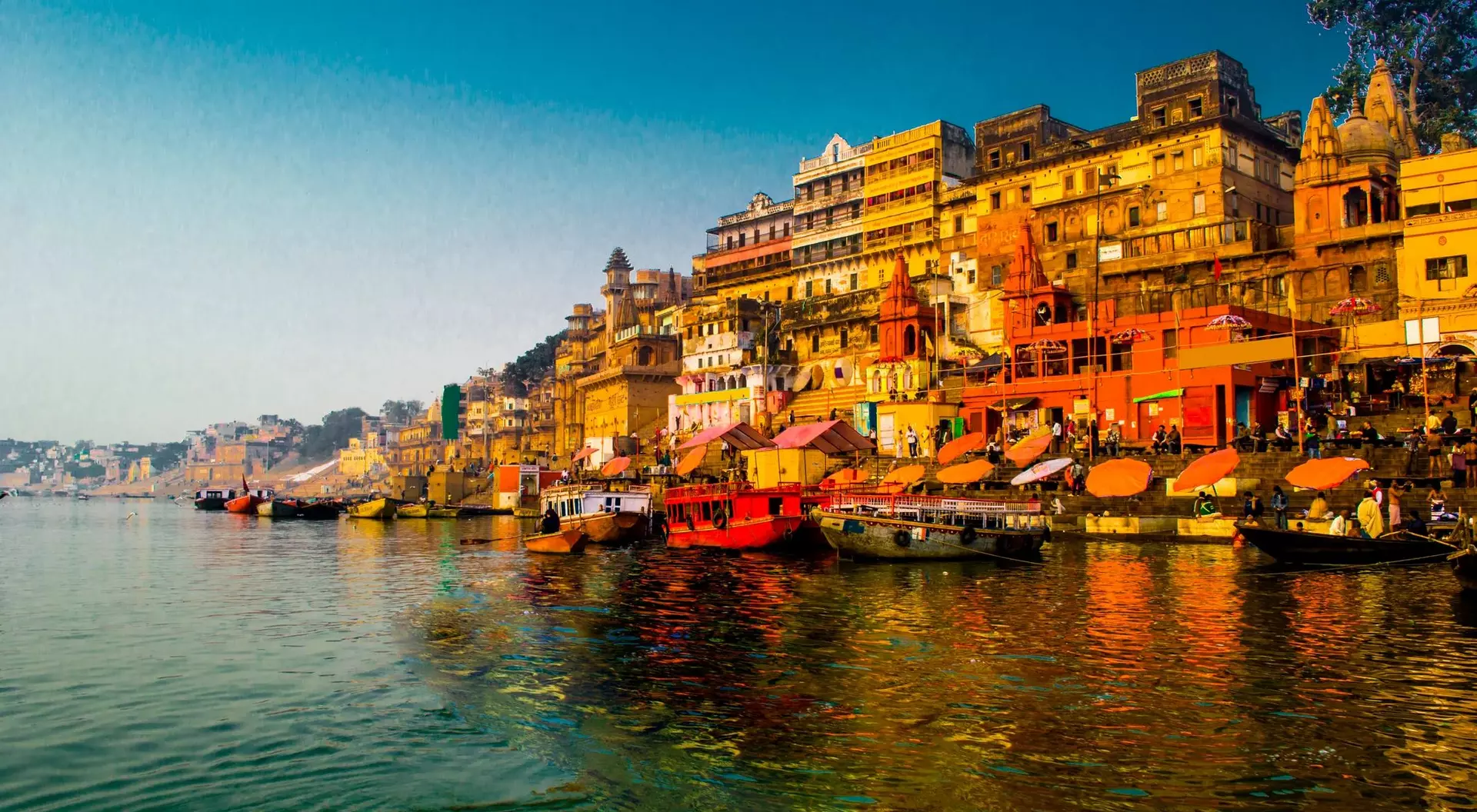 View of the Ganges River during the morning with intense colour shitting the shoreline of Varanasi, India