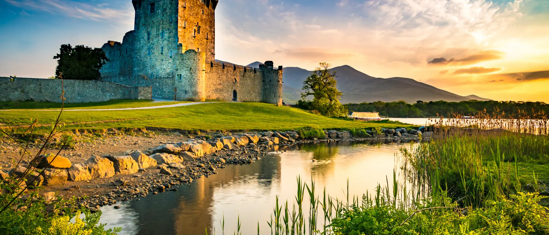 Ross Castle is one of many medieval ruins strewn across Ireland. Ancient old Fortress Ross Castle ruin with lake and grass in Ireland during golden hour