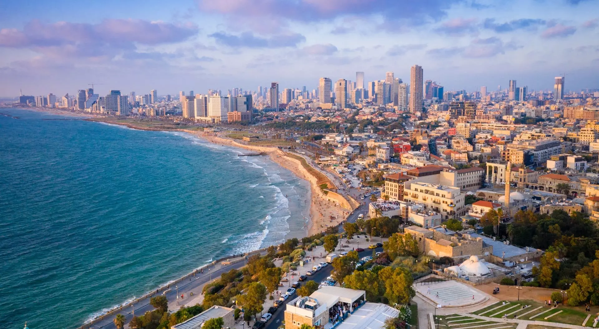 High Angle View Of Buildings By Sea Against Sky