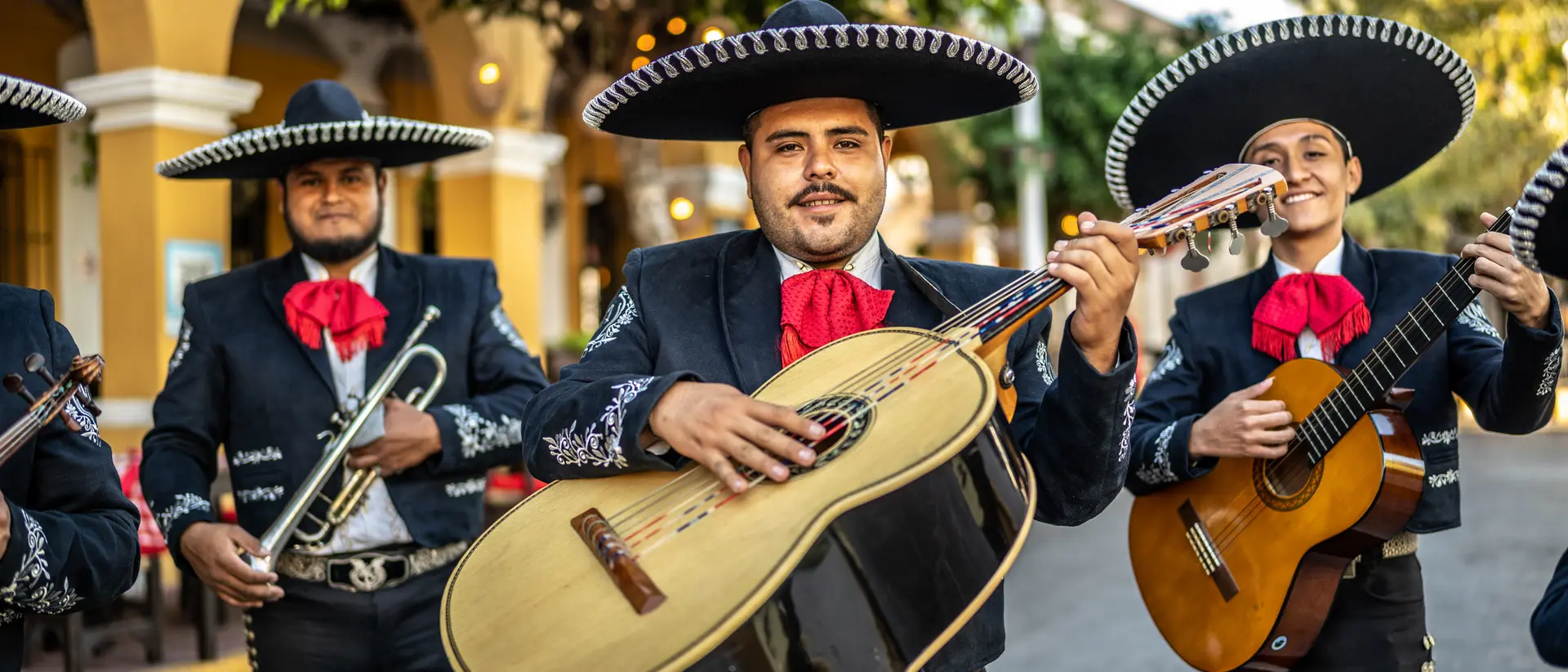 Mexico City A group of Mexican mariachi musicians hold their instruments in an old town square.