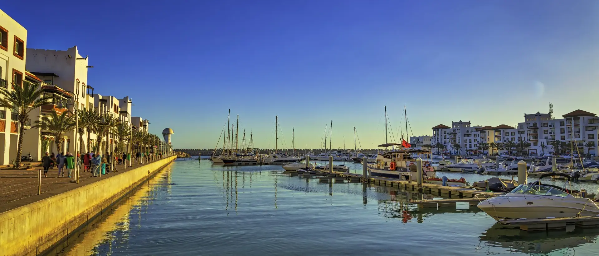 Agadir, Morocco marina with boats and old buildings along the sea