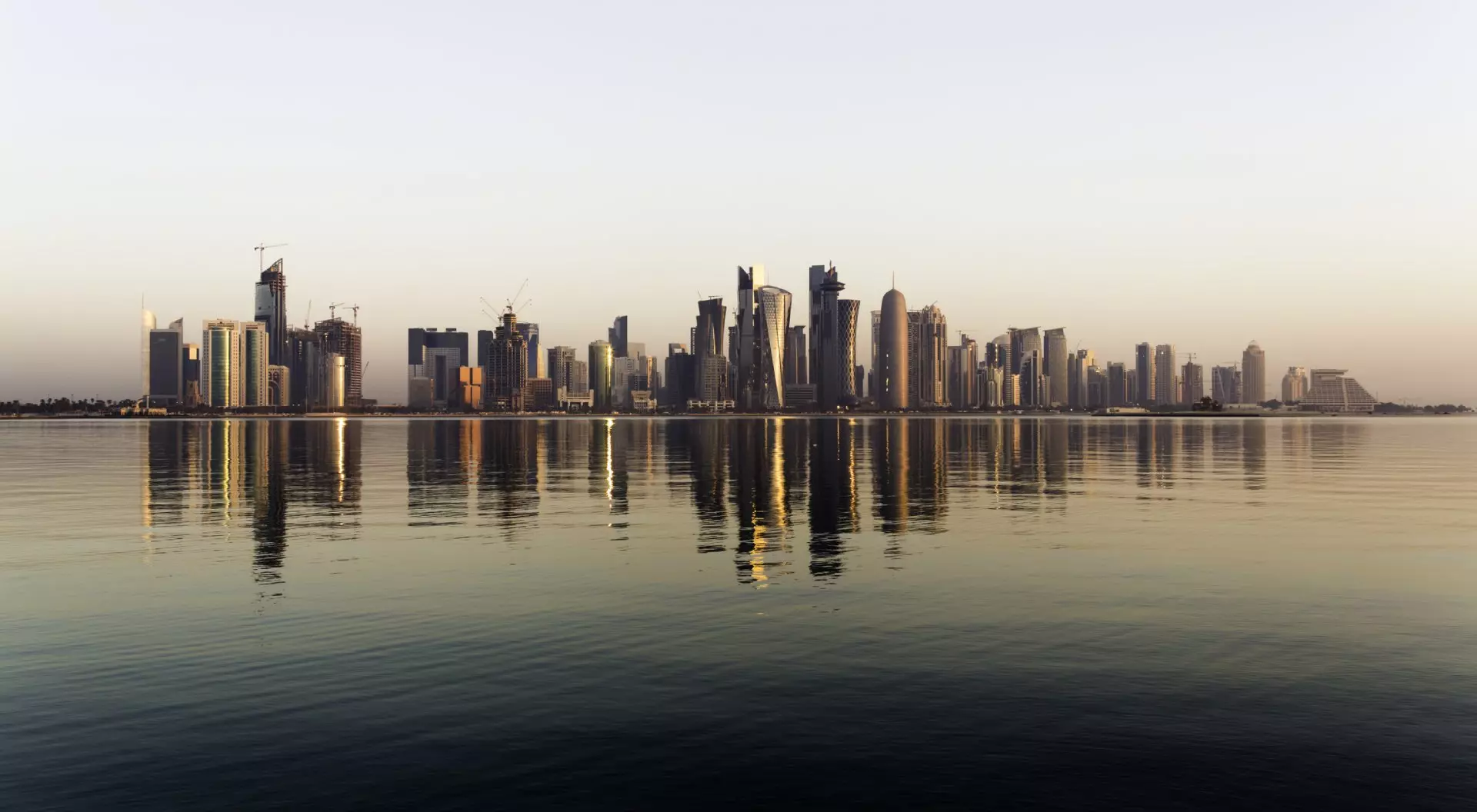 Early morning sunrise golden light hits the city of Doha