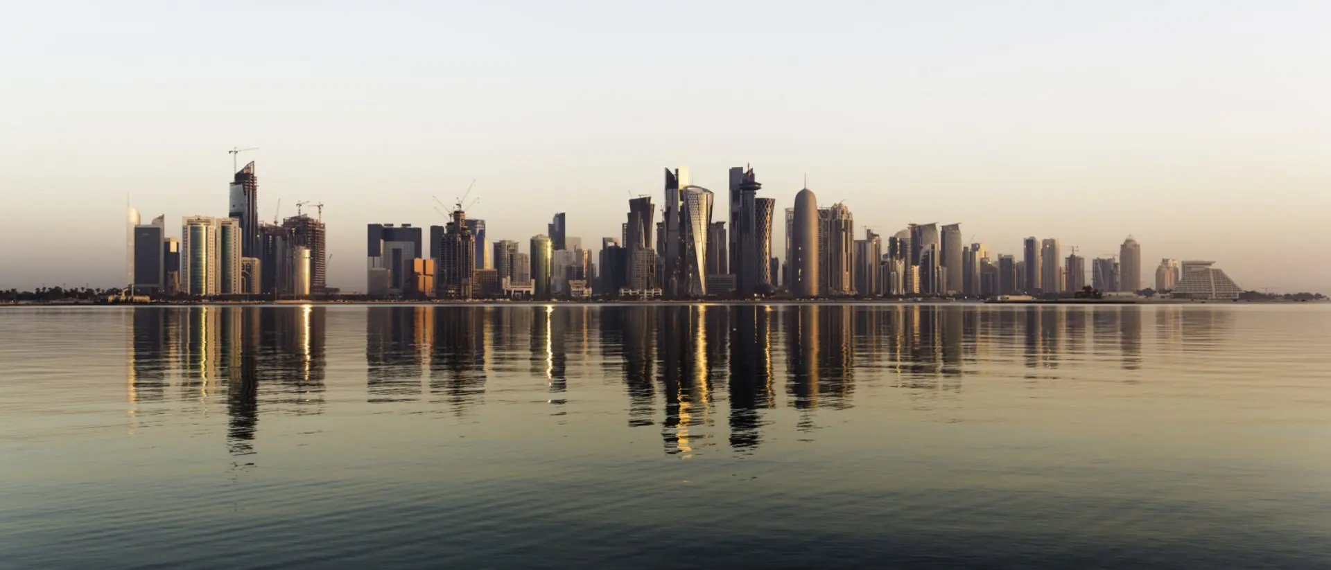 Early morning sunrise golden light hits the city of Doha