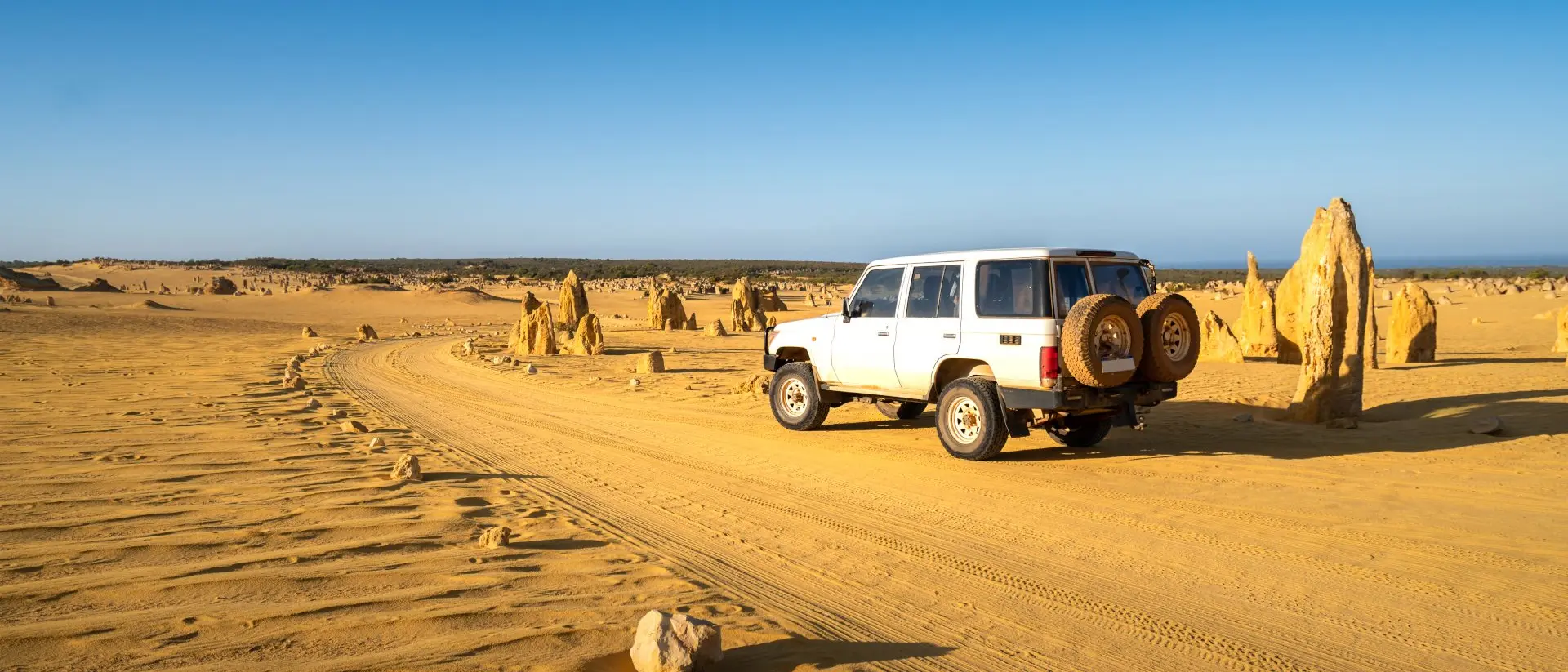 Four-wheel-drive car in the Pinnacles Desert, Nambung National Park, Western Australia.