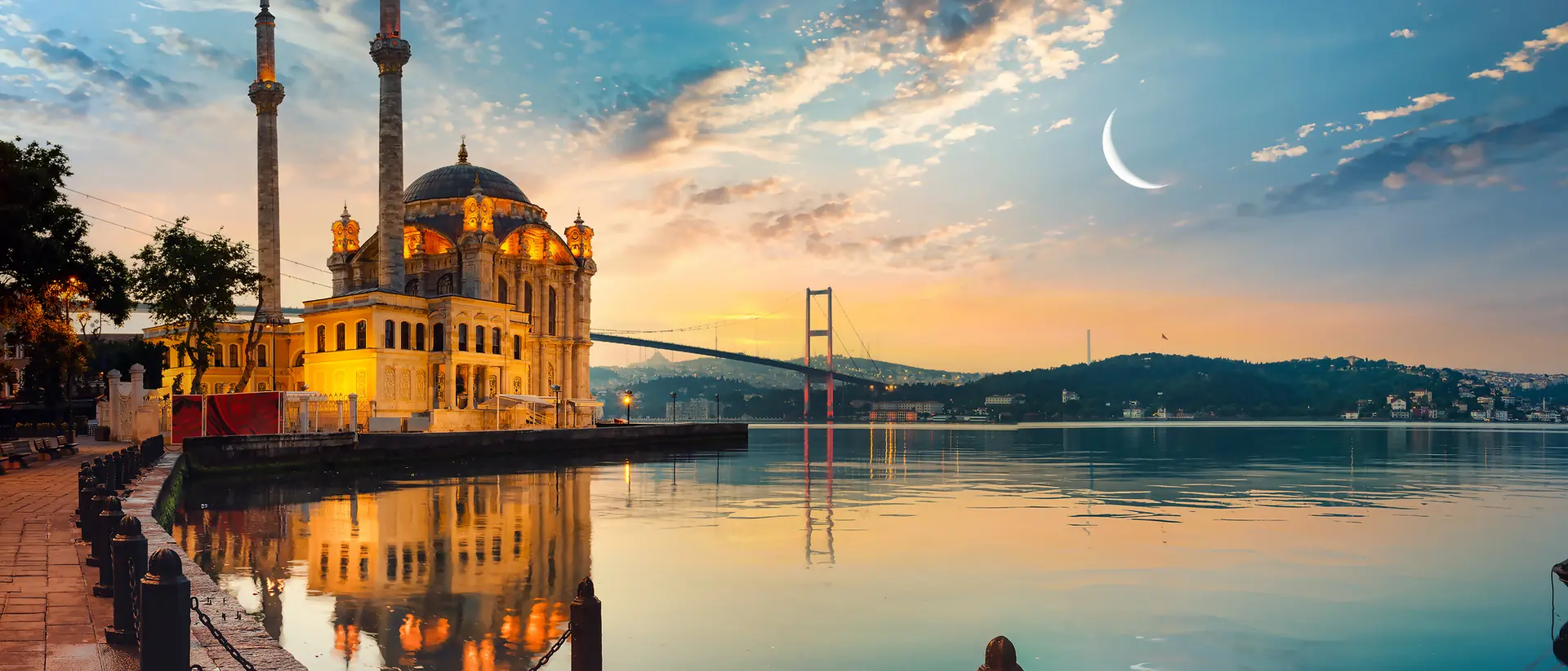 Ortakay Mosque, Istanbul View of Ortakay Mosque in Istanbul with the Bosporus Bridge and the moon in the sky.