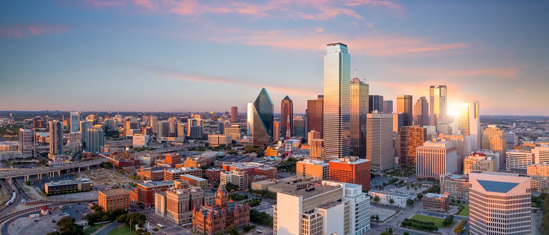 the city skyline of Dallas, Texas at sunset