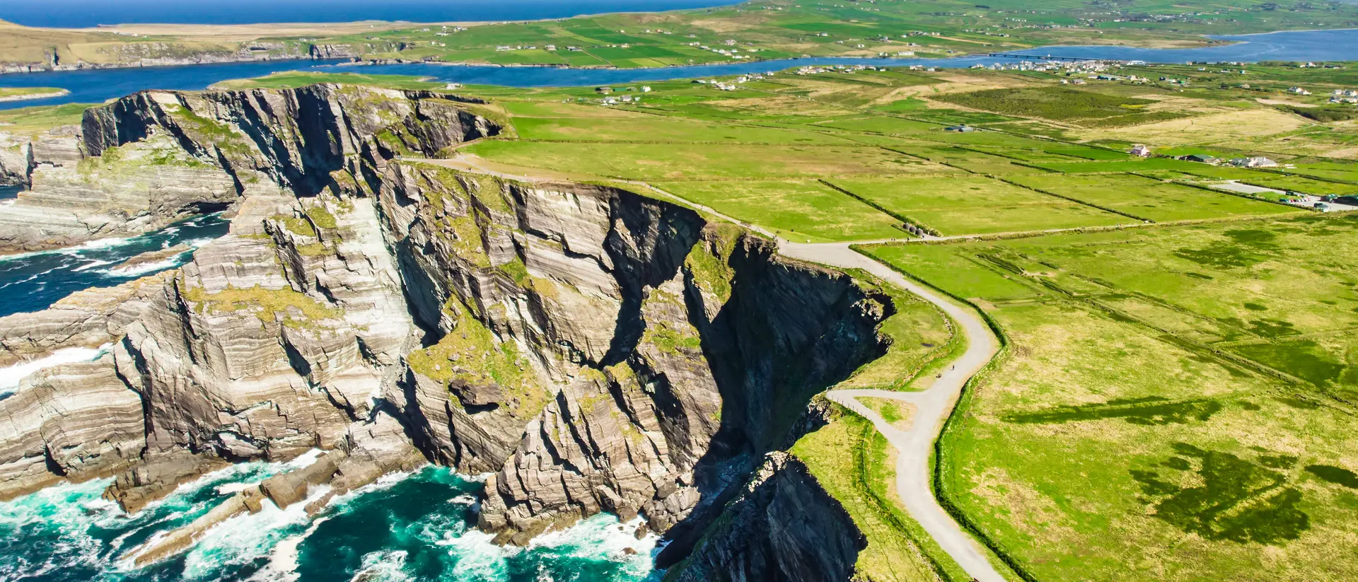 Amazing wave lashed Kerry Cliffs, the most spectacular cliffs in County Kerry, Ireland. Tourist attractions on famous Ring of Kerry route.
