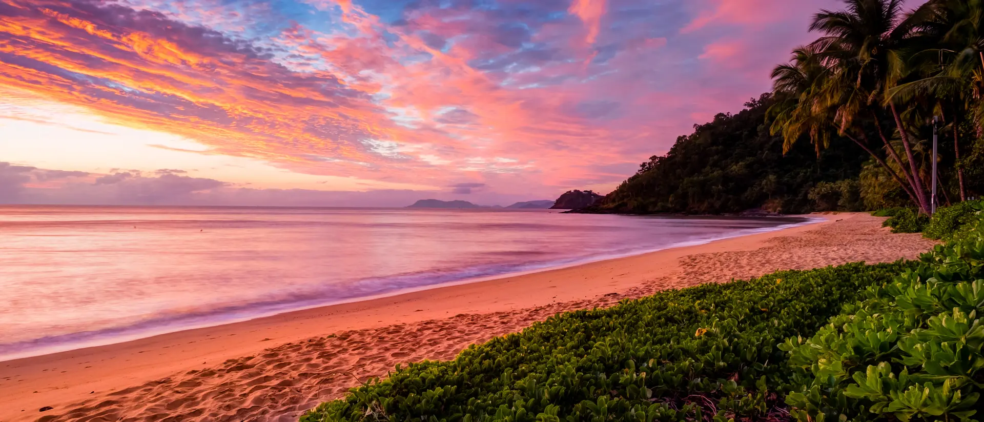 Admire the painted sunset skies of Cairns
