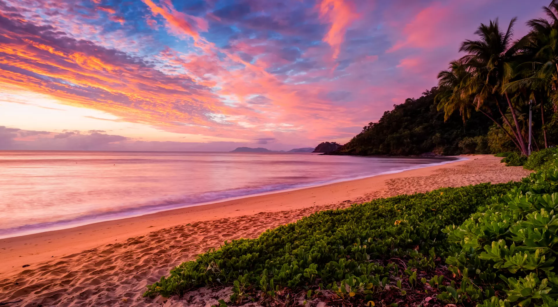 Admire the painted sunset skies of Cairns