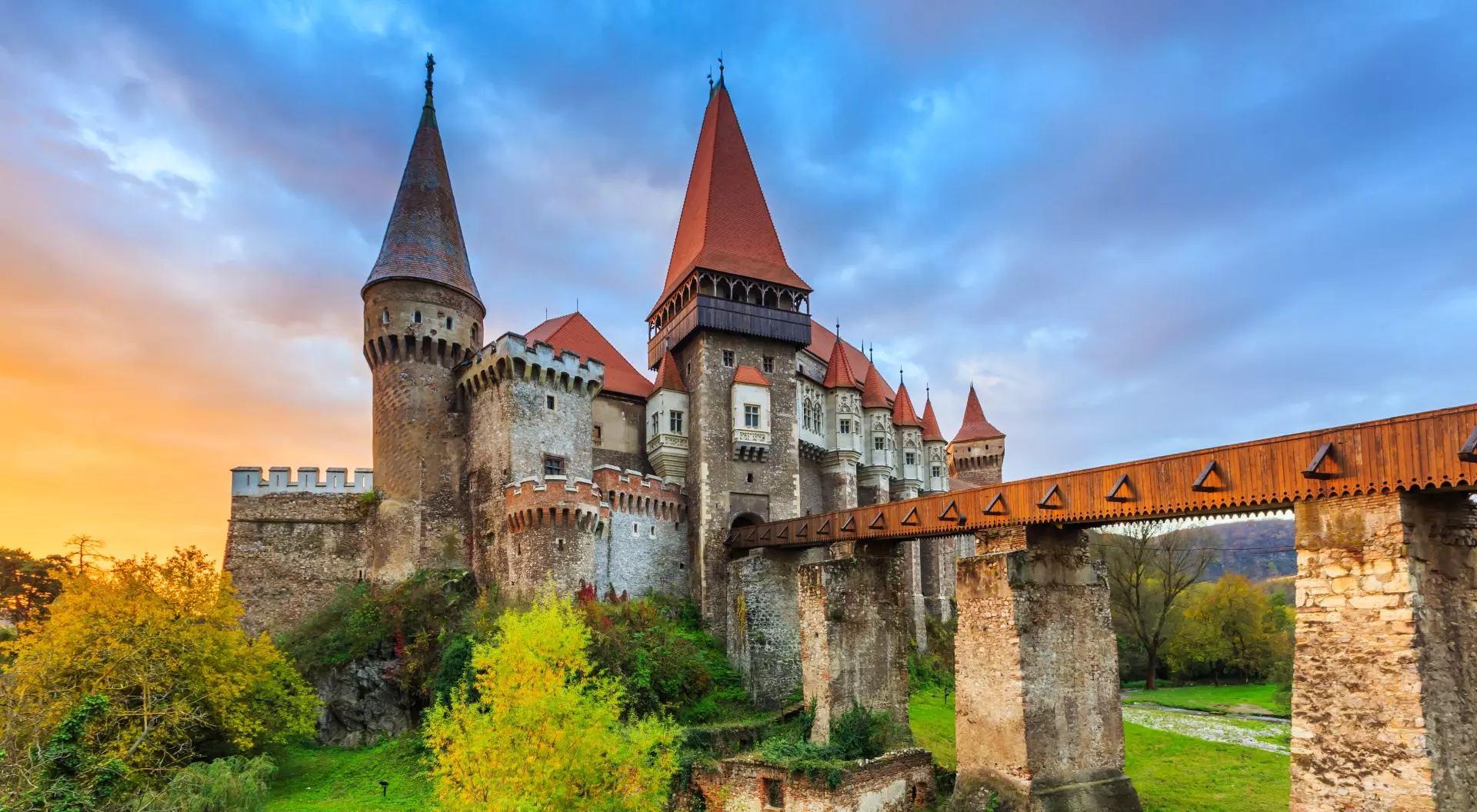 a medieval castle with a bridge over a river.
