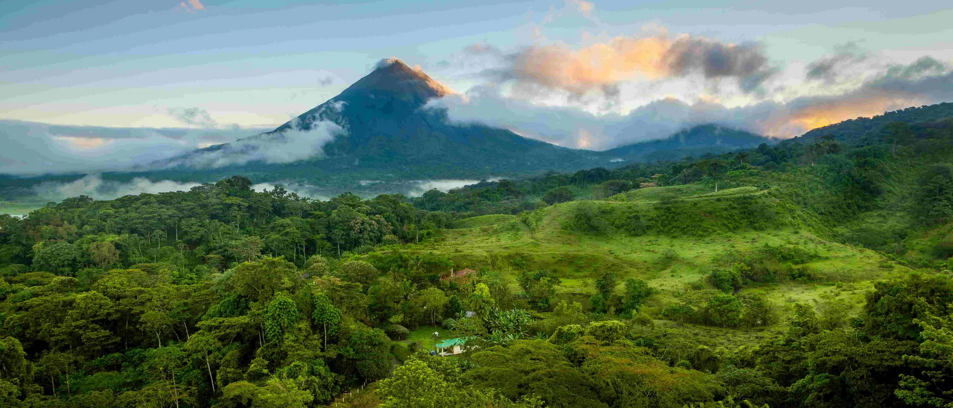 arenal volcano with clouds and green forests in Costa Rica