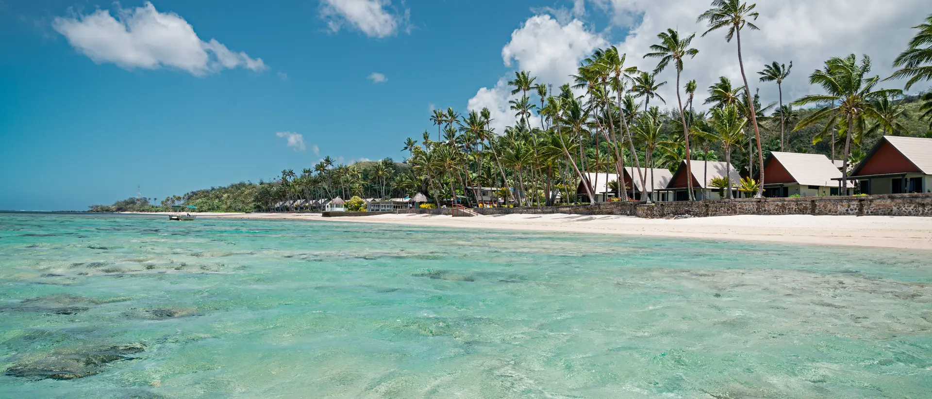beach with villas and clear waters in the tropics