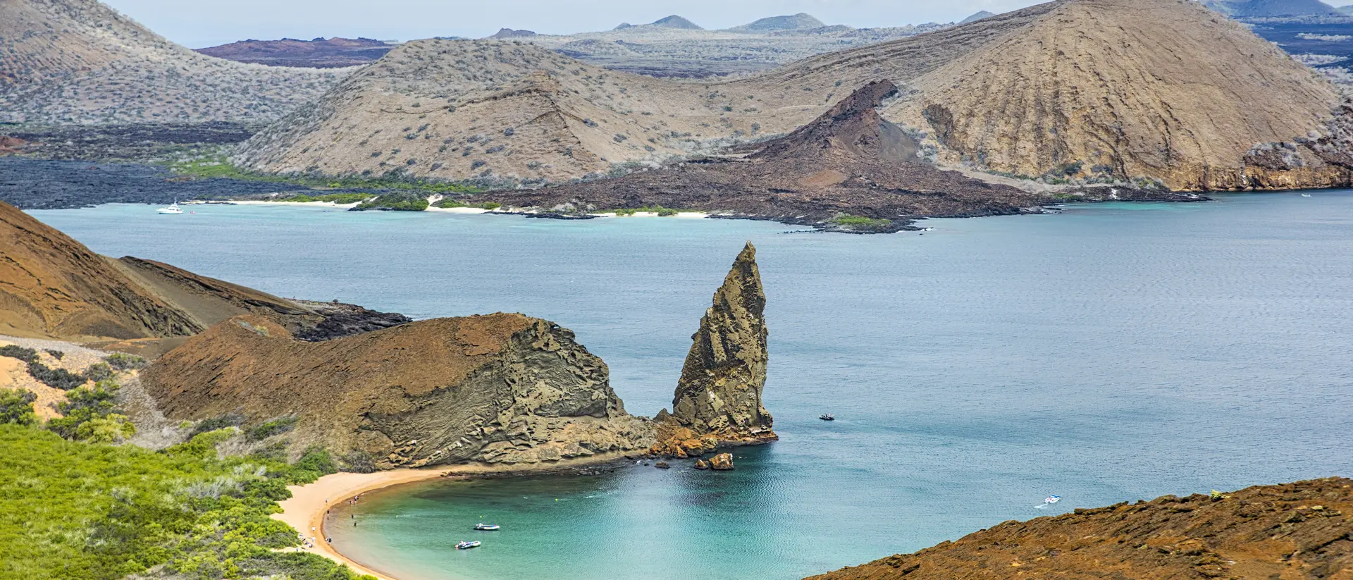 Aerial view of the famous Pinnacle Rock on the small island of Bartolome, Galapagos, Ecuador. In the background is Santiago island.