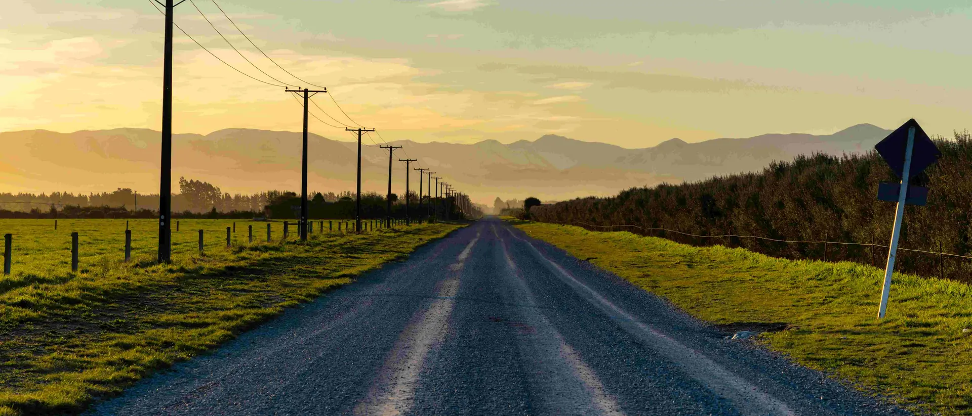 Sunset draws closer on a road running towards the Southern Alps, on New Zealand's South Island